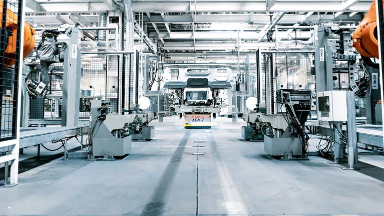 Flexible, automated guided vehicle systems in a truck assembly plant intelligently network mobile units.